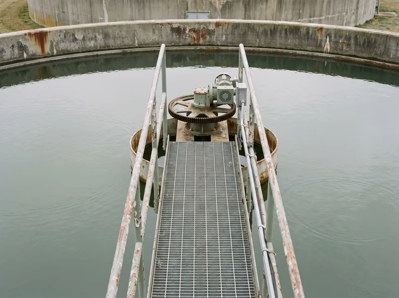A grated walkway leading to the centre drive of a circular clarifier